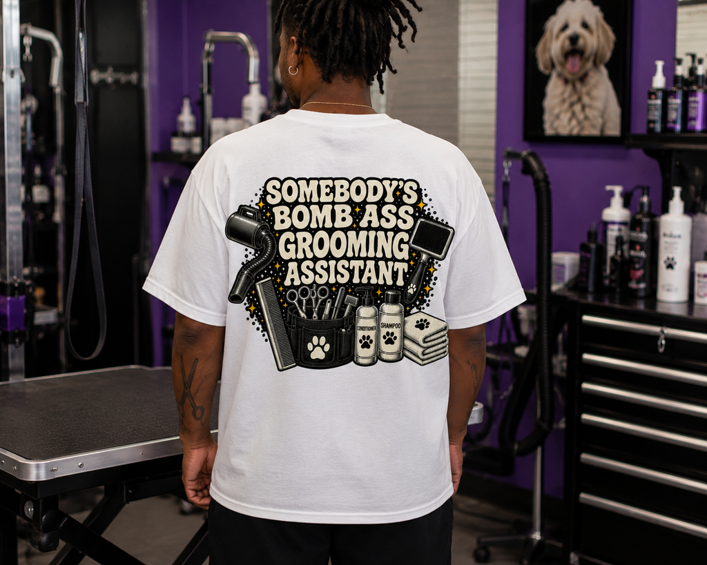 SOMEBODY'S BOMB ASS GROOMING ASSISTANT T-SHIRT