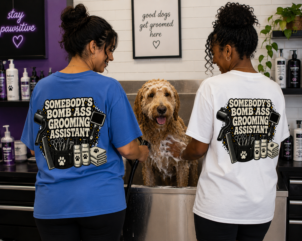 SOMEBODY'S BOMB ASS GROOMING ASSISTANT T-SHIRT